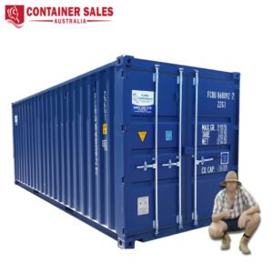 Blue shipping container with double doors; a man in a hat crouches beside it for scale, with Container Sales Australia branding above left.