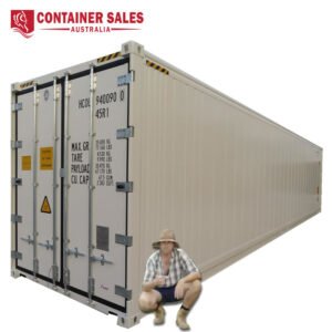 Beige shipping container stretching into the distance with a man in a hat seated at the front corner; Container Sales Australia logo in the top-left corner.