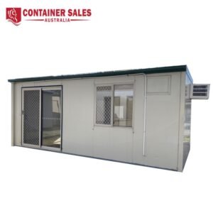 Beige modular container building with a sliding glass door, a window with a security grille, and a wall-mounted air conditioner; Container Sales Australia logo at the top left.